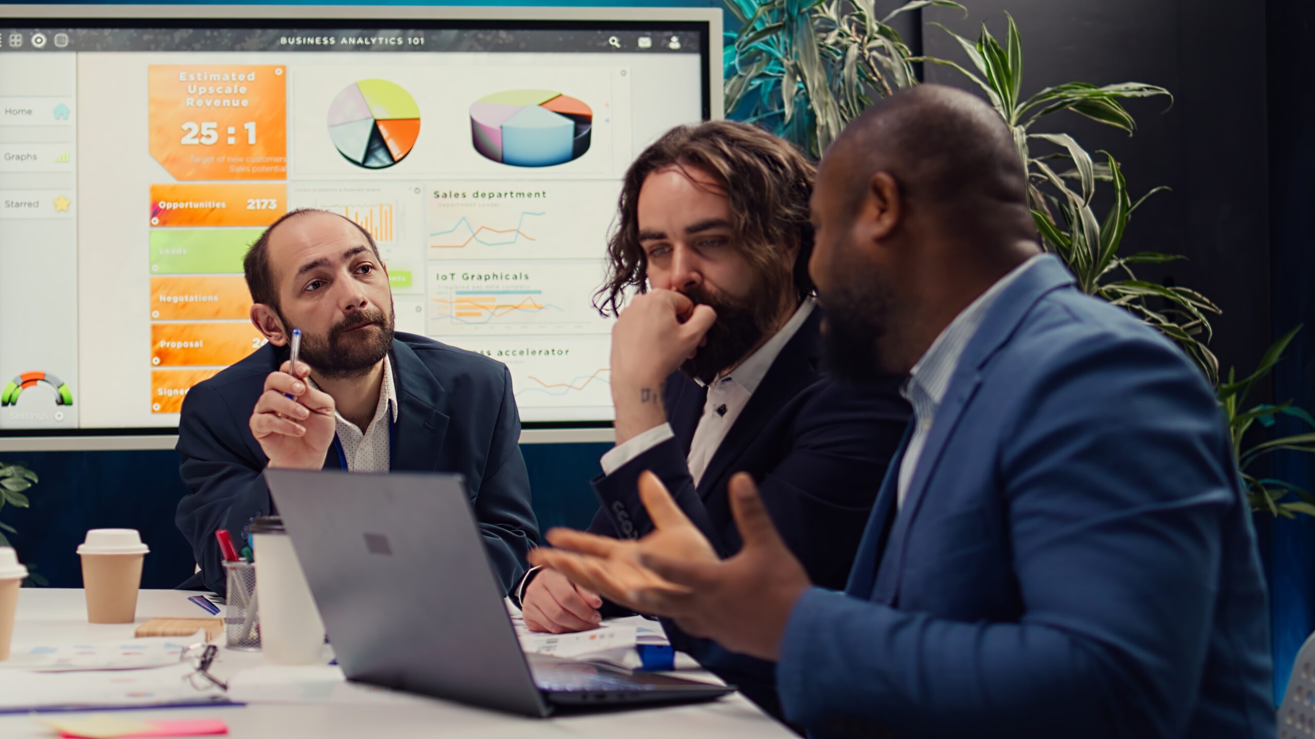 Corporate workers looking into project updates and timelines in boardroom, establishing budget and activities to achieve strategic objectives in a competitive business environment. Camera B.